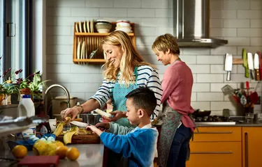 couple cooking with son in kitchen