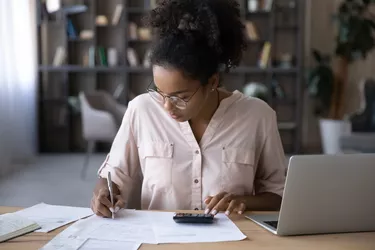 African American woman manage budget paying bills online