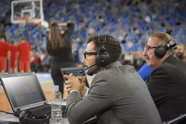 Basketball commentators using laptops