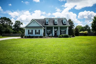 Front View of blue house with siding in the suburbs