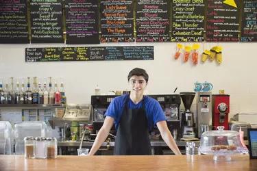 Mixed race teenage boy working in cafe