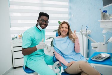 Dentist with his female patient, happy and healthy