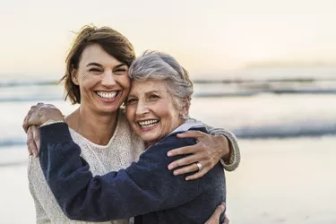 Portrait of happy daughter embracing senior woman