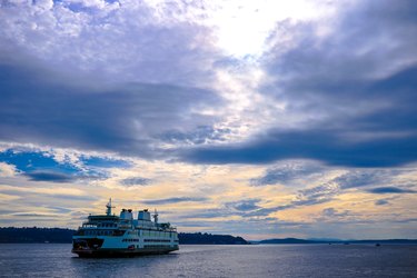 Luxury ship sailing to port with beautiful sky.