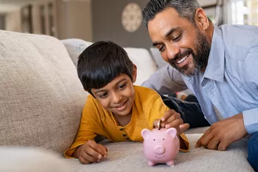 boy saving money in piggybank