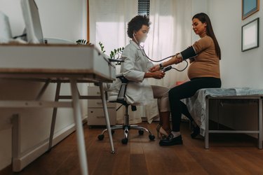 Doctor with a pregnant woman during an examinations