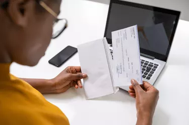 African American Holding Paycheck