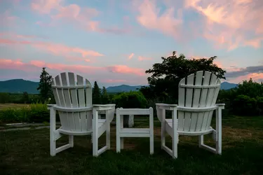 Relaxing Anirondack Chairs looking out on a beautiful mountain sunset