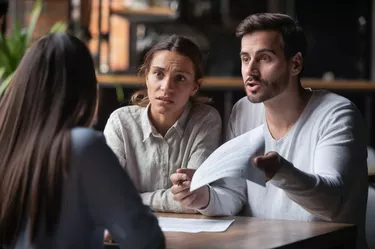 Angry couple arguing with bank manager complain on bad contract