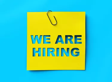 "We are hiring" yellow banner on blue textured background