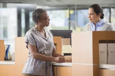 Client and bank employee talking by counter