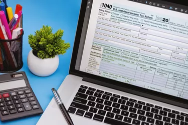Tax Form 1040 on Laptop Screen.