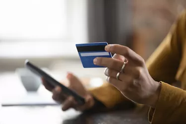 Bank customer woman using credit card, mobile phone