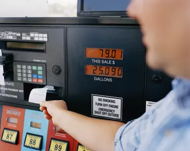 Man getting receipt from gas pump