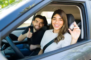 Latinx couple taking their new car for a ride