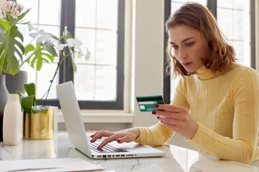 Woman pays for online purchases by card