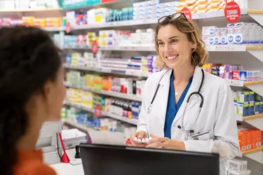 Pharmacist giving medicine to customer