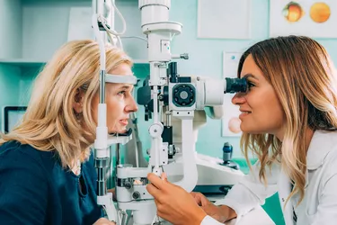 Optometrist Examining Patient At Clinic