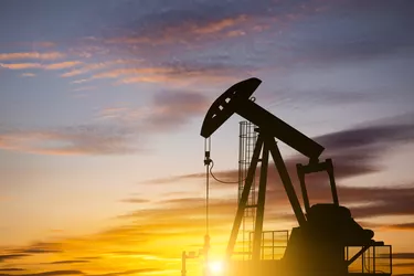 Oil pump on a sunset background. World Oil Industry
