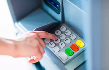 A person withdrawing money from a atm machine