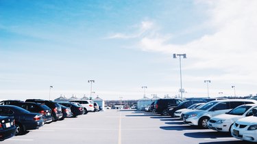 Cars Parked At Parking Lot Against Sky