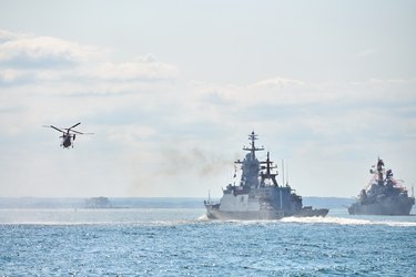 Battleships War Ships Corvette During Naval Exercises And Helicopter Maneuvering Over Sea Waters