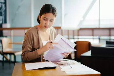 Close-up Young woman Paying Bills Online at home