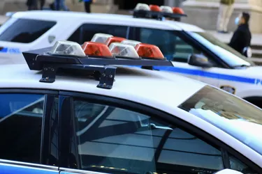 Police vehicles with overhead strobe lights at a crime scene