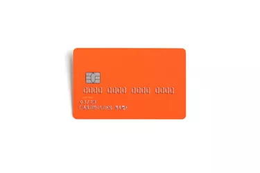 Orange credit card isolated on a white background with natural shadow
