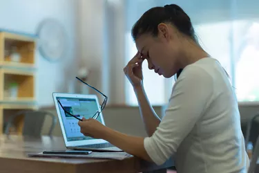 Tired stressed out woman working on her computer. Business.