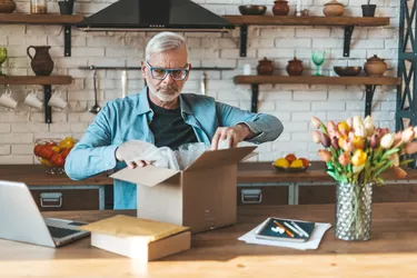 Return of online purchases. Unhappy customer with a parcel from an online store at home