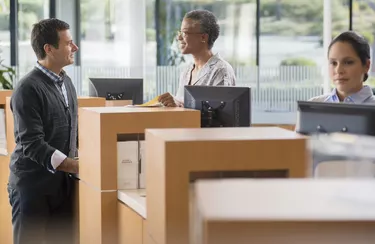 Client and bank employee talking by counter