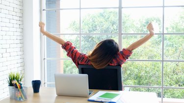 Work from home, Stretch for relax, Young asian woman stretching body while working with laptop computer at her desk home office, Back of female student raised arms take rest from online education