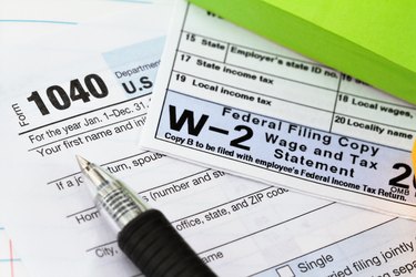 IRS 1040 tax form and w-2 wage statement: tax preparation concept.