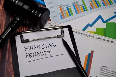 Financial Penalty write on paperwork isolated on wooden table.