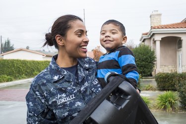 Navy mom carrying young son