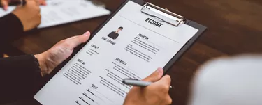 Businesswoman submits resume employer to review job application information on the desk, presents the ability for the company to agree with the position of the job.