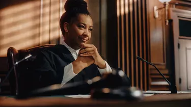 Cinematic Court of Law Trial: Humane Portrait of Impartial Smiling Female Judge Listening Happily to Jury's Verdict. Wise, Incorruptible, Fair Justice Imprisoning Criminals and Protecting The Innocent