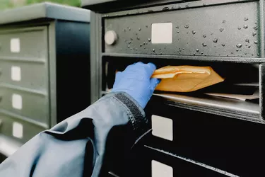 Woman Retrieves Package Wearing Protective Gloves