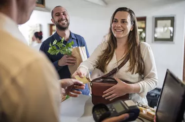 Customer paying with credit card in farm shop