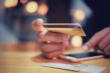 Man Hands Holding Using Credit Card For Online Shopping Payment With Smartphone