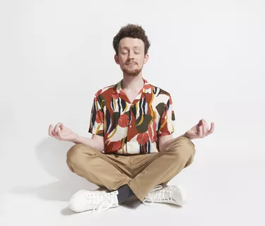 Young man sitting in mediation pose