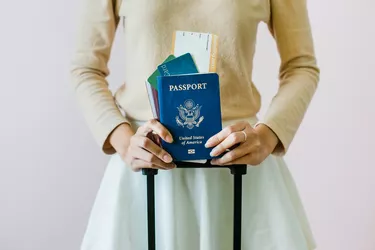 Closeup of girl holding passports and boarding pass