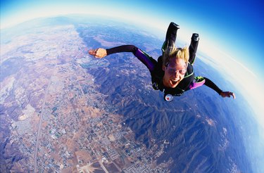 Woman skydiving, aerial view, California, USA (wide angle)