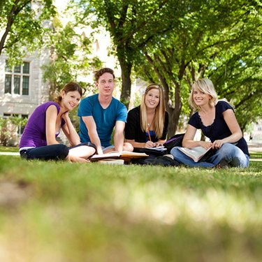Students working in library, focus on foreground