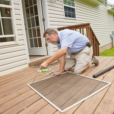 Man caulking window