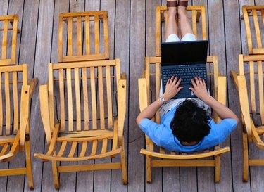 Woman Working on Laptop on Cruise Ship
