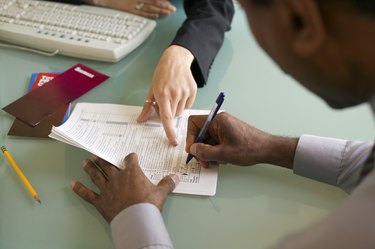 Man signing financial paperwork