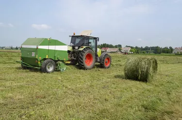 tractor bailer collect hay in agriculture field