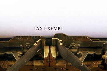 paper in old-style typewriter sayin Tax Exempt